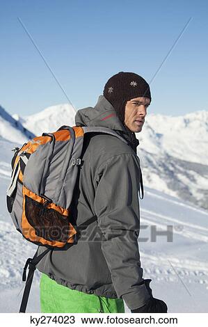 Young man in ski wear looking away View Large Photo Image Stock Image - Young man in ski wear looking away. Fotosearch