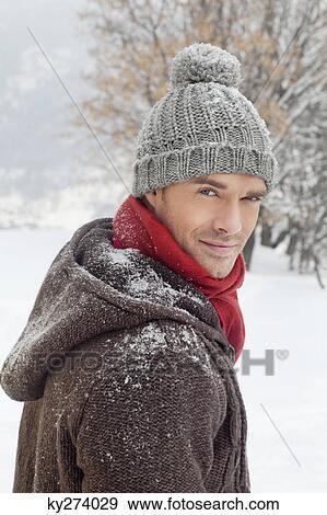 Young man in winter clothes looking at camera View Large Photo Image Stock Photo - Young man in winter clothes looking at camera. Fotosearch