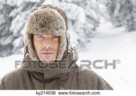 Young man in winter clothes looking at camera View Large Photo Image Stock Photo - Young man in winter clothes looking at camera. Fotosearch