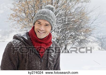 Young man in winter clothes smiling at camera View Large Photo Image Picture - Young man in winter clothes smiling at camera. Fotosearch