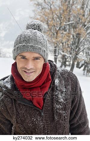 Young man in winter clothes smiling at camera View Large Photo Image Stock Image - Young man in winter clothes smiling at camera. Fotosearch