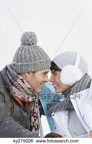Young couple embracing, touching foreheads View Large Photo Image Stock Photograph - Young couple embracing, touching foreheads. Fotosearch