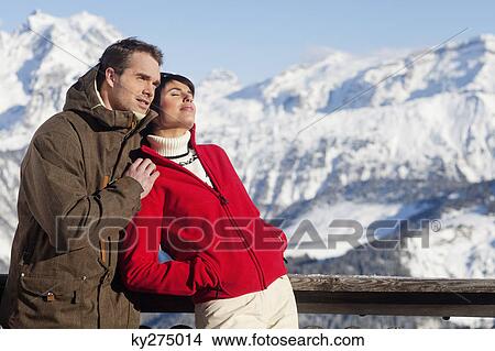 Picture - Young couple enjoying winter sun. Fotosearch