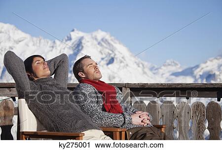 Young couple enjoying winter sun View Large Photo Image Stock Image - Young couple enjoying winter sun. Fotosearch