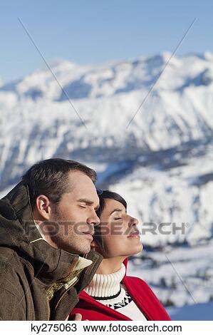 Young couple enjoying winter sun View Large Photo Image Stock Image - Young couple enjoying winter sun. Fotosearch