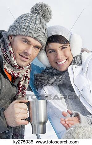 Young couple in ski wear resting View Large Photo Image Stock Photograph - Young couple in ski wear resting. Fotosearch