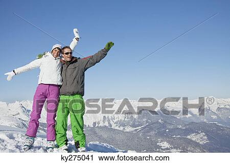 Young couple in ski wear smiling at camera View Large Photo Image Stock Image - Young couple in ski wear smiling at camera. Fotosearch
