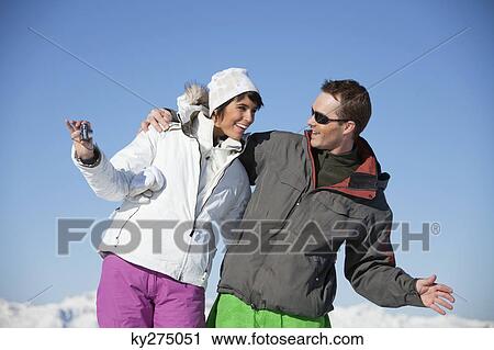 Young couple in ski wear taking self portrait View Large Photo Image Stock Image - Young couple in ski wear taking self portrait. Fotosearch