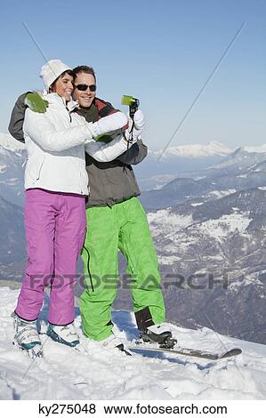 Young couple in ski wear taking self portrait View Large Photo Image Stock Photo - Young couple in ski wear taking self portrait. Fotosearch