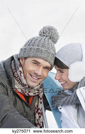 Young couple in winter clothes embracing View Large Photo Image Stock Image - Young couple in winter clothes embracing. Fotosearch