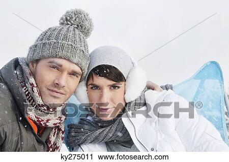 Young couple in winter clothes looking at camera View Large Photo Image Stock Image - Young couple in winter clothes looking at camera. Fotosearch