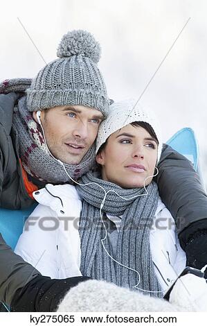Young couple in winter clothes, listening to music together View Large Photo Image Stock Photography - Young couple in winter clothes, listening to music together. Fotosearch