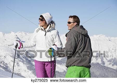 Young couple of skiers looking away View Large Photo Image Stock Photography - Young couple of skiers looking away. Fotosearch