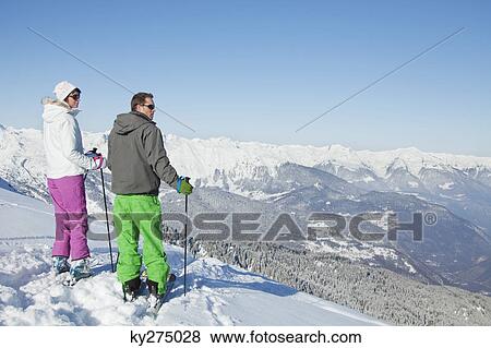 Young couple of skiers on slope View Large Photo Image Stock Photo - Young couple of skiers on slope. Fotosearch