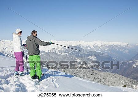 Young couple of skiers on slope View Large Photo Image Stock Photography - Young couple of skiers on slope. Fotosearch