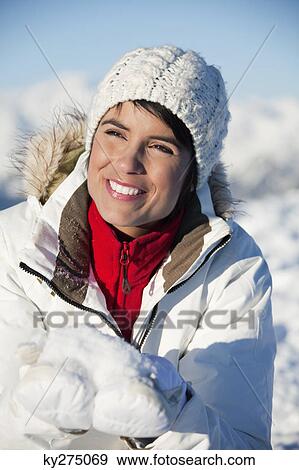 Young smiling woman holding snow View Large Photo Image Stock Photo - Young smiling woman holding snow. Fotosearch