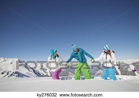 Couple and daughter walking in snow View Large Photo Image Stock Image - Couple and daughter walking in snow. Fotosearch