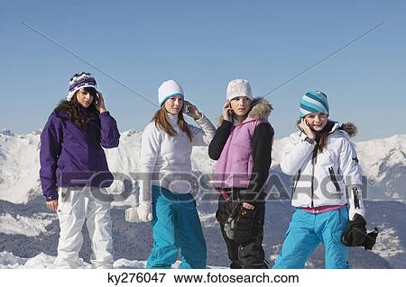 Four teenage girls in ski clothes using their mobile phones View Large Photo Image Stock Photo - Four teenage girls in ski clothes using their mobile phones. Fotosearch
