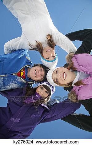 Four teenagers in ski clothes, smiling at camera View Large Photo Image Picture - Four teenagers in ski clothes, smiling at camera. Fotosearch