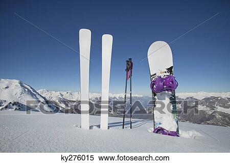Stock Photography - Skis and snowboard stuck in the snow. Fotosearch