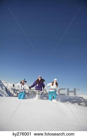Three teenage girls in ski clothes, running in snow View Large Photo Image Stock Image - Three teenage girls in ski clothes, running in snow. Fotosearch