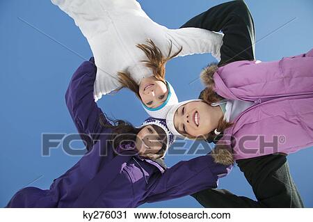 Three teenage girls in ski clothes, smiling at camera View Large Photo Image Stock Image - Three teenage girls in ski clothes, smiling at camera. Fotosearch