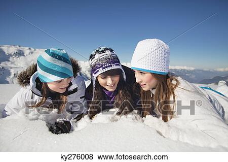 Three teenage girls in ski clothes, lying in snow View Large Photo Image Stock Photo - Three teenage girls in ski clothes, lying in snow. Fotosearch