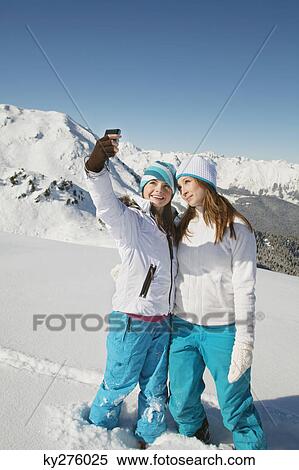 Two teenage girls in ski clothes, taking self portrait View Large Photo Image Stock Photography - Two teenage girls in ski clothes, taking self portrait. Fotosearch