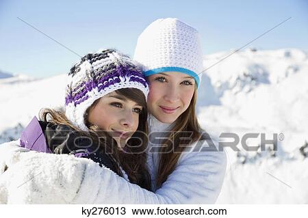 Two teenage girls in winter clothes, embracing View Large Photo Image Stock Image - Two teenage girls in winter clothes, embracing. Fotosearch