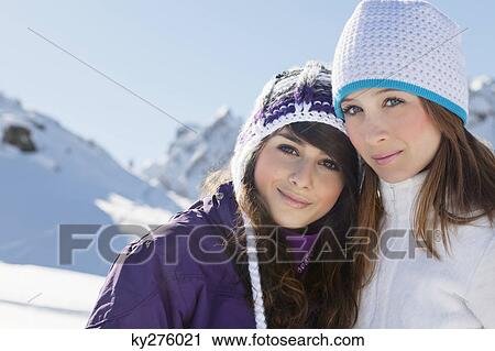 Two teenage girls in winter clothes, embracing View Large Photo Image Stock Image - Two teenage girls in winter clothes, embracing. Fotosearch