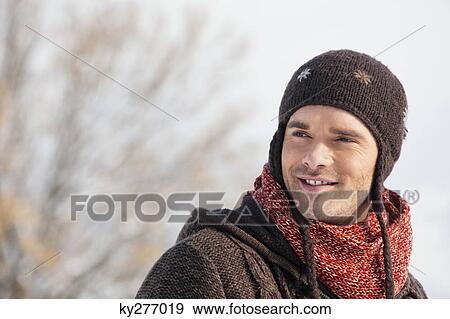 Stock Photo - Portrait of young man in winter clothes. Fotosearch