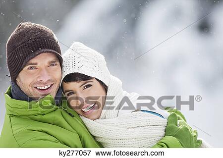 Young couple embracing, smiling at camera View Large Photo Image Stock Photo - Young couple embracing, smiling at camera. Fotosearch