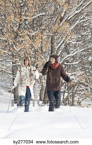 Young couple snowshoeing View Large Photo Image Picture - Young couple snowshoeing. Fotosearch