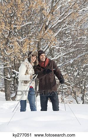 Young couple snowshoeing View Large Photo Image Stock Image - Young couple snowshoeing. Fotosearch