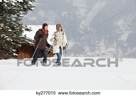 Stock Photography - Young couple snowshoeing. Fotosearch