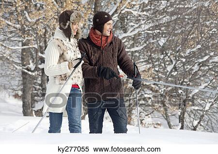 Stock Photography - Young couple snowshoeing. Fotosearch
