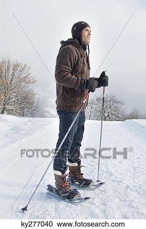 Young man wearing snowshoes View Large Photo Image Stock Image - Young man wearing snowshoes. Fotosearch