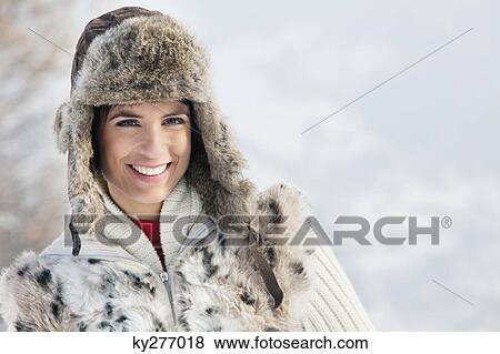 Stock Photo - Young woman in winter clothes smiling at camera. Fotosearch