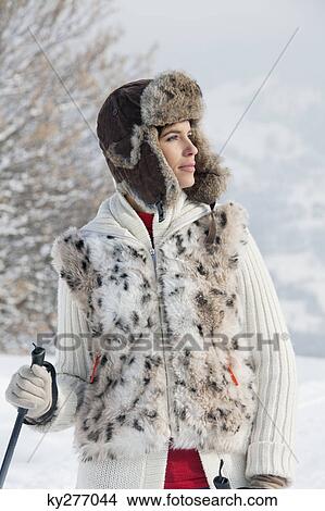 Young woman with ski poles, looking away View Large Photo Image Picture - Young woman with ski poles, looking away. Fotosearch