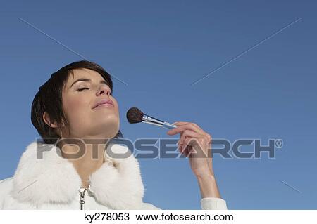 Young woman applying make-up View Large Photo Image Stock Image - Young woman applying make-up. Fotosearch
