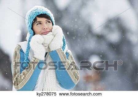 Young woman in winter clothes looking up View Large Photo Image Stock Photography - Young woman in winter clothes looking up. Fotosearch