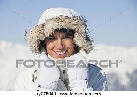 Young woman in winter clothes smiling at camera View Large Photo Image Stock Image - Young woman in winter clothes smiling at camera. Fotosearch