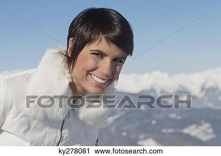 Young woman in winter clothes smiling at camera View Large Photo Image Stock Image - Young woman in winter clothes smiling at camera. Fotosearch