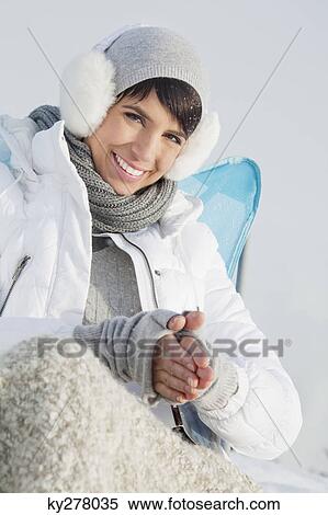 Young woman in winter clothes smiling at camera View Large Photo Image Stock Photography - Young woman in winter clothes smiling at camera. Fotosearch
