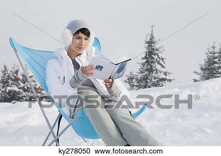 Young woman reading in snow View Large Photo Image Stock Image - Young woman reading in snow. Fotosearch