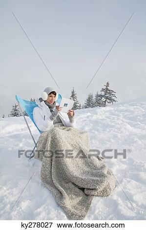Young woman reading in snow View Large Photo Image Stock Photo - Young woman reading in snow. Fotosearch