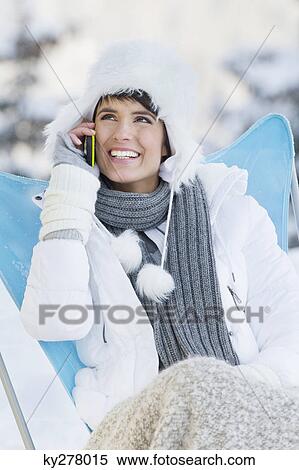 Young woman using mobile phone in snow View Large Photo Image Stock Photography - Young woman using mobile phone in snow. Fotosearch