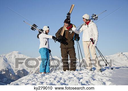Couple and daughter carrying skis View Large Photo Image Stock Image - Couple and daughter carrying skis. Fotosearch