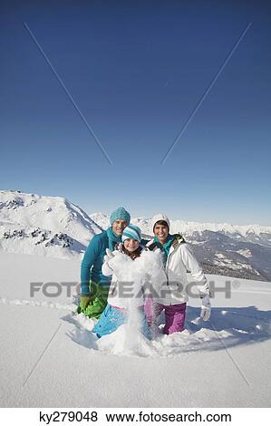 Couple and daughter in ski wear, throwing snow in air View Large Photo Image Stock Photo - Couple and daughter in ski wear, throwing snow in air. Fotosearch