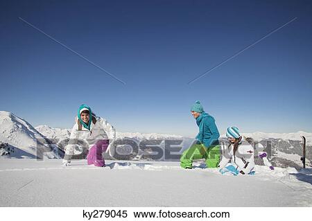 Stock Photography - Couple and daughter walking in snow. Fotosearch